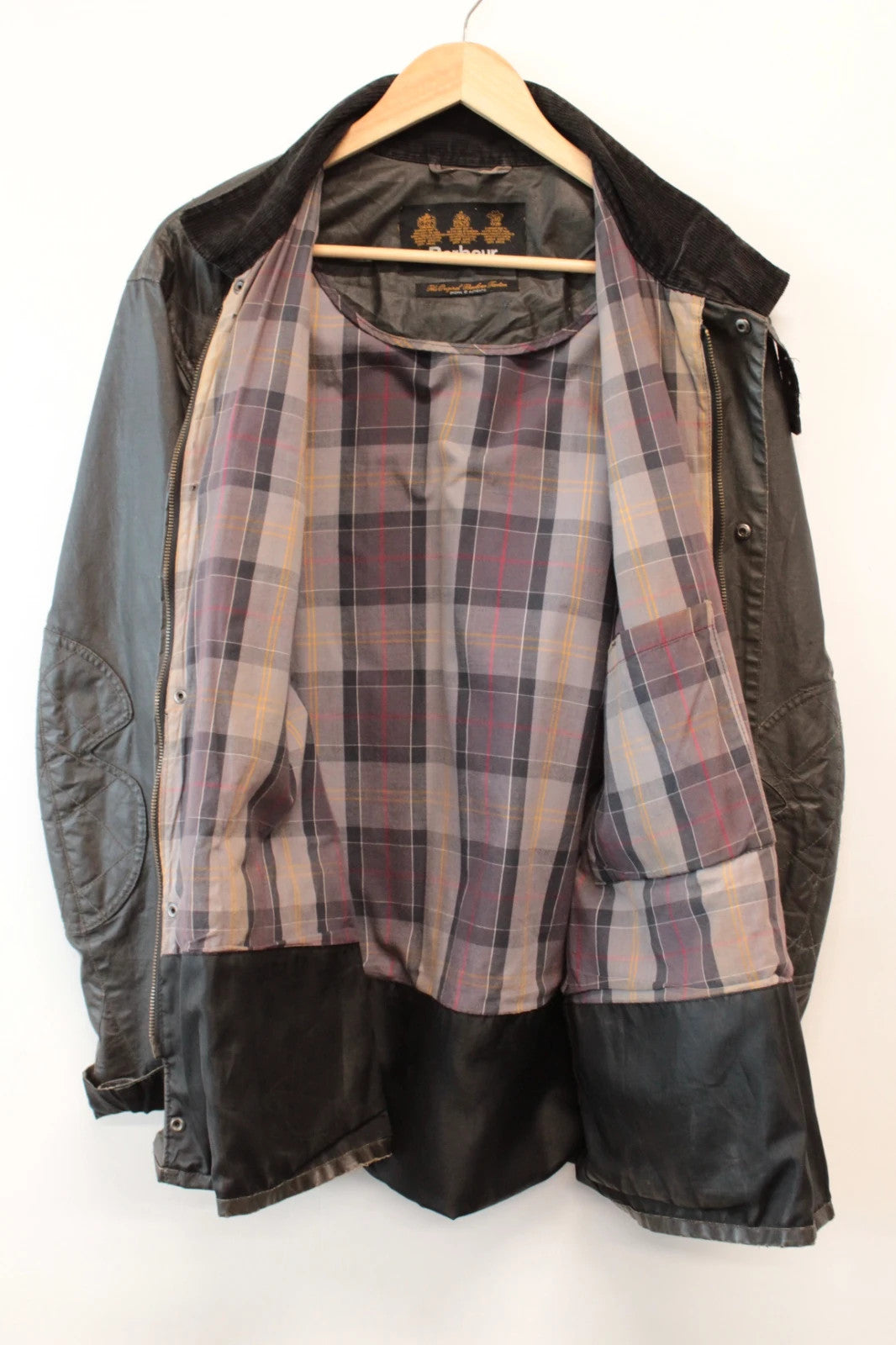 Barbour black waxed utility jacket with Gucci leather accents and multi-pocket design.