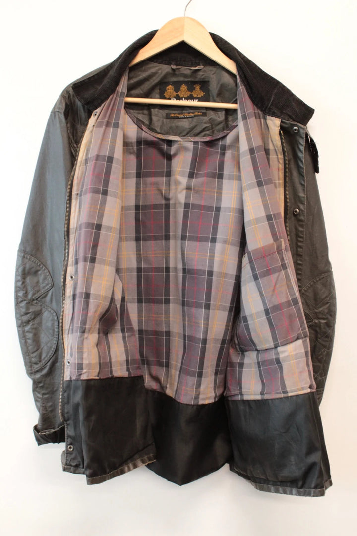 Barbour black waxed utility jacket with Gucci leather accents and multi-pocket design.