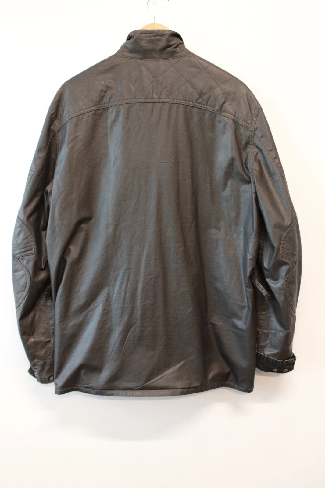 Barbour black waxed utility jacket with Gucci leather accents and multi-pocket design.