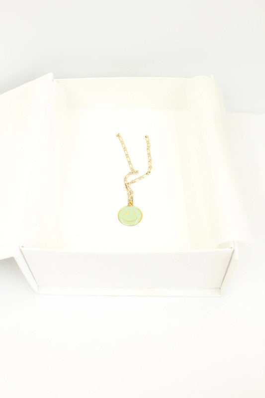 WE11DONE gold necklace with mint green enamel smile pendant on figaro chain.