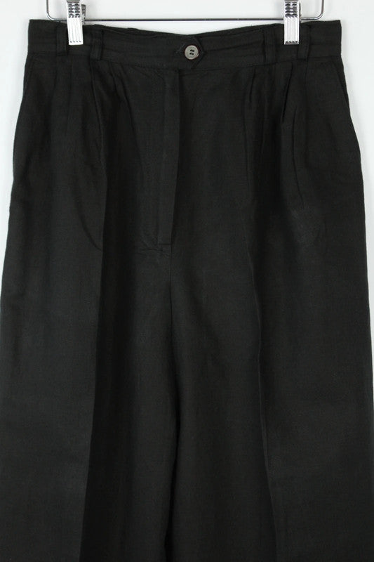 Rosner black linen wide-leg trousers with pleated front and center press crease.