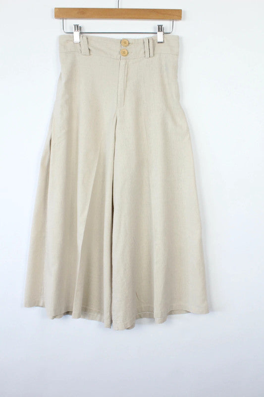 Vintage Dressing beige wide leg culottes with double-stacked wooden button waist closure.