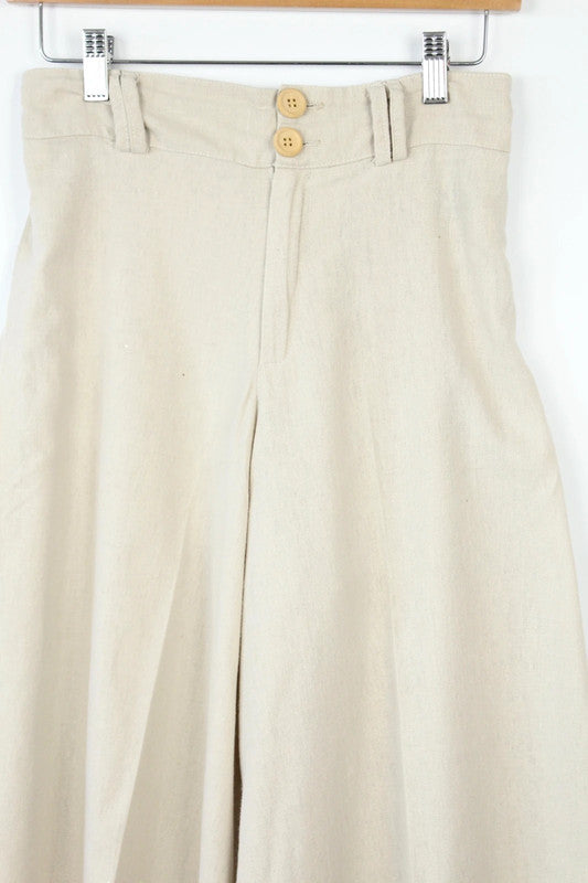 Vintage Dressing beige wide leg culottes with double-stacked wooden button waist closure.