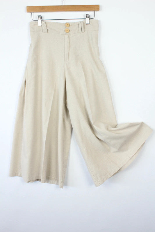 Vintage Dressing beige wide leg culottes with double-stacked wooden button waist closure.