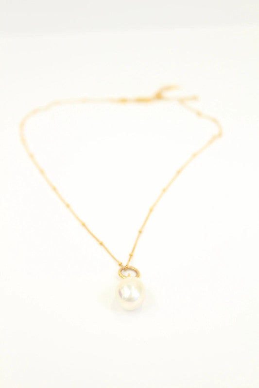 Missoma gold vermeil necklace with white freshwater pearl pendant and dainty satellite chain.