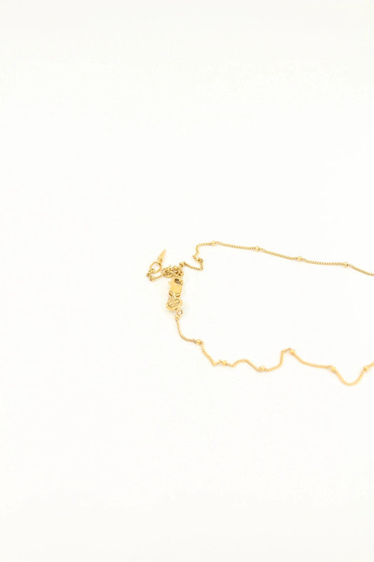 Missoma gold vermeil necklace with white freshwater pearl pendant and dainty satellite chain.