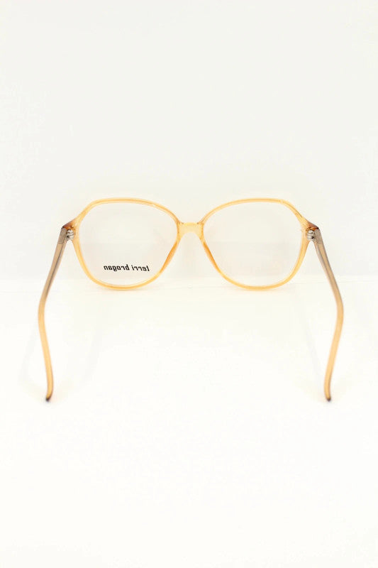 Optyl vintage sunglasses orange pink translucent oval frame with logo detail.