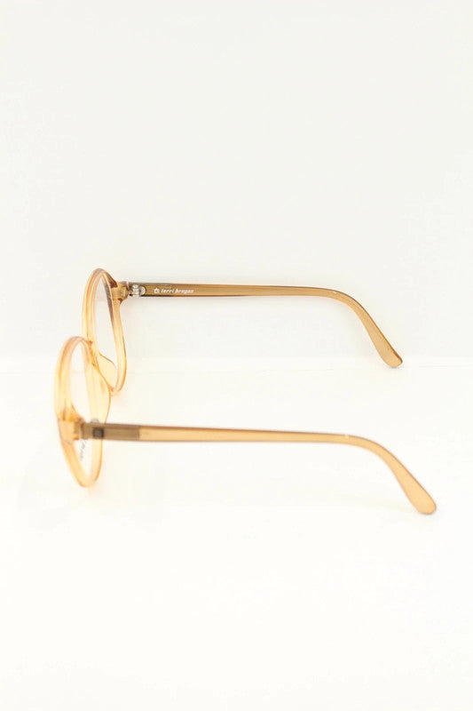 Optyl vintage sunglasses orange pink translucent oval frame with logo detail.