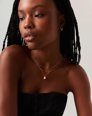 Missoma gold vermeil necklace with white freshwater pearl pendant and dainty satellite chain.