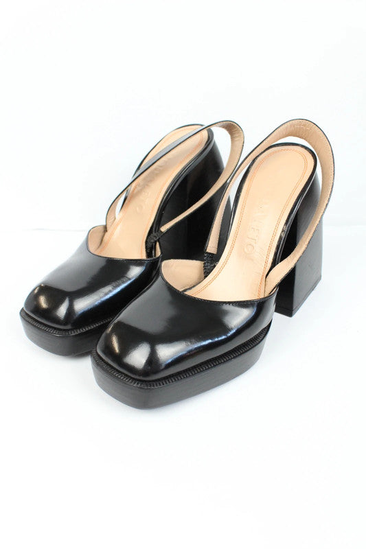 Nodaleto black patent leather slingback platform shoes with oversized square toe and block heel.