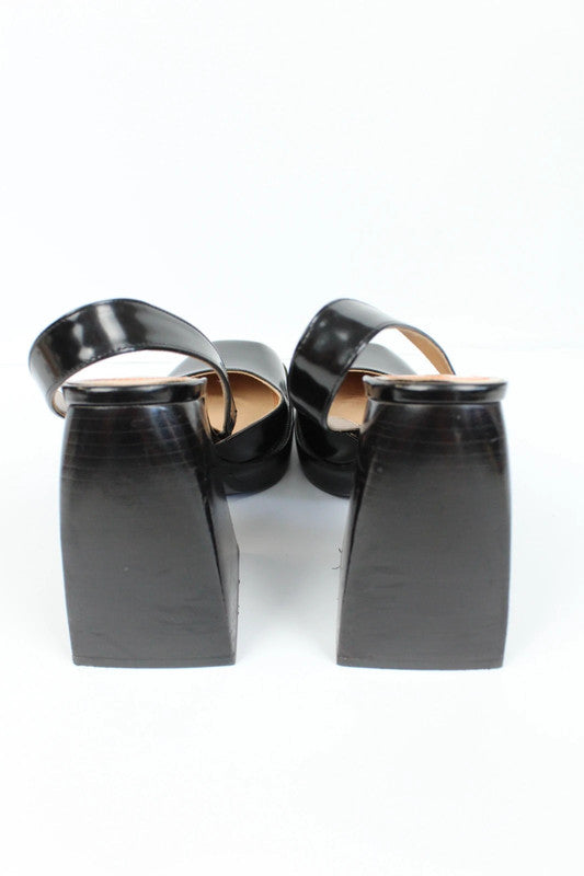 Nodaleto black patent leather slingback platform shoes with oversized square toe and block heel.