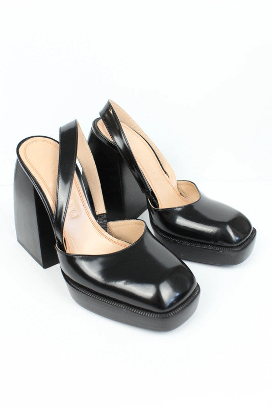 Nodaleto black patent leather slingback platform shoes with oversized square toe and block heel.