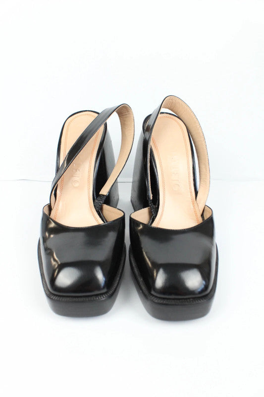 Nodaleto black patent leather slingback platform shoes with oversized square toe and block heel.
