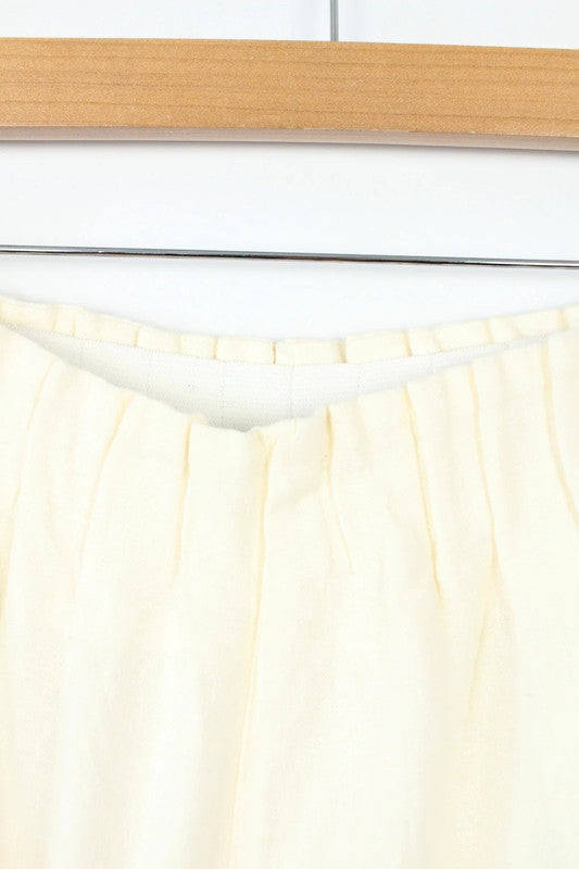 Vintage Dressing cream linen wide-leg culottes high-waisted, lightweight fabric, minimalist design.