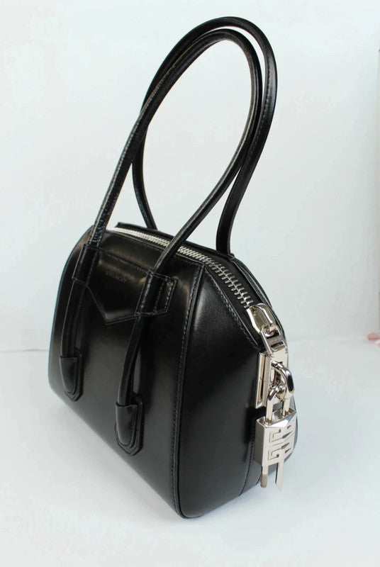 Givenchy black mini handbag with pentagonal logo patch and silver-tone hardware.