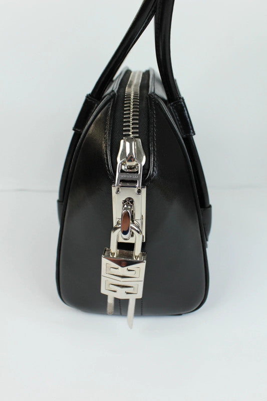 Givenchy black mini handbag with pentagonal logo patch and silver-tone hardware.