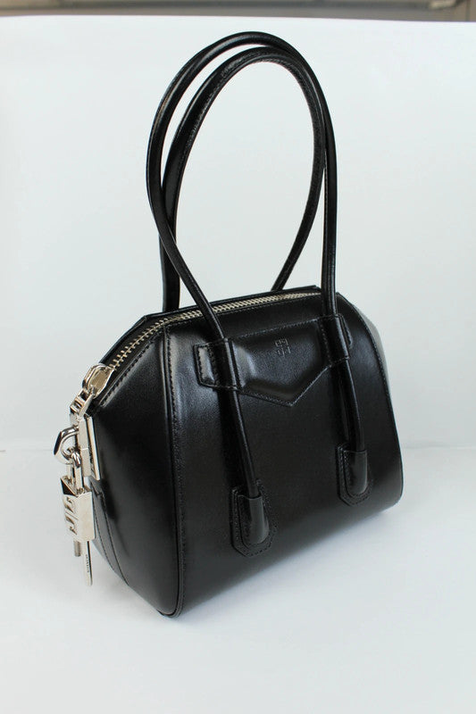 Givenchy black mini handbag with pentagonal logo patch and silver-tone hardware.