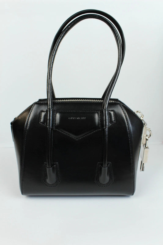 Givenchy black mini handbag with pentagonal logo patch and silver-tone hardware.