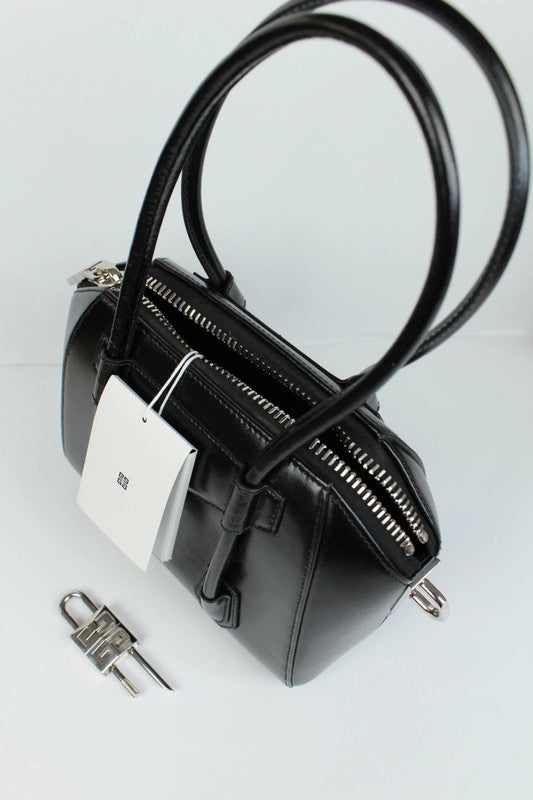 Givenchy black mini handbag with pentagonal logo patch and silver-tone hardware.