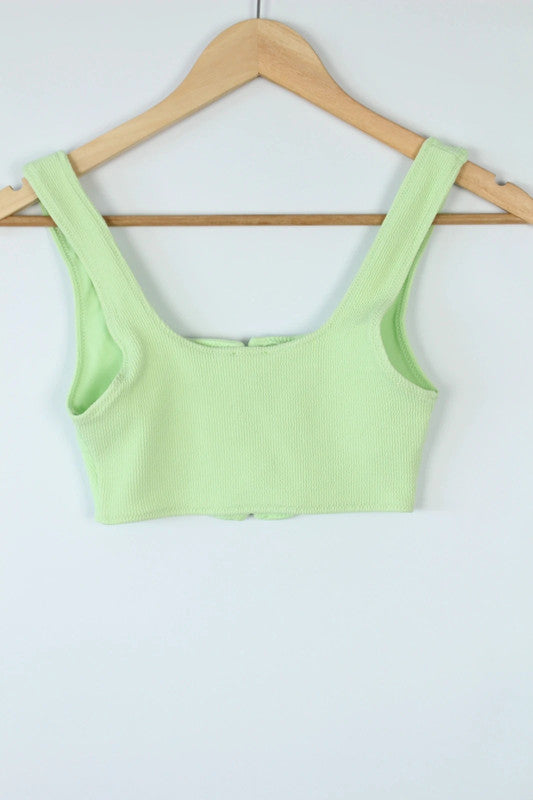Ganni green ribbed lace-up corset bralette with square neckline and adjustable ties.