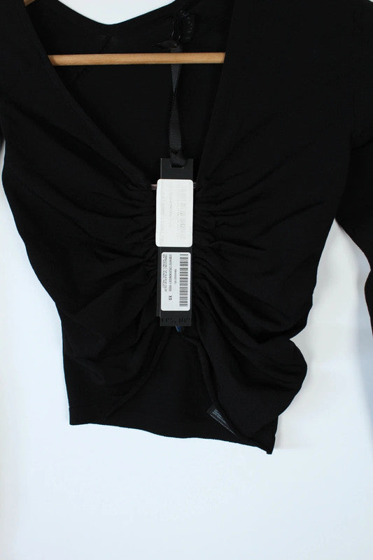 Ben Taverniti Unravel Project black asymmetric cut-out turtleneck vest in soft stretch knit.