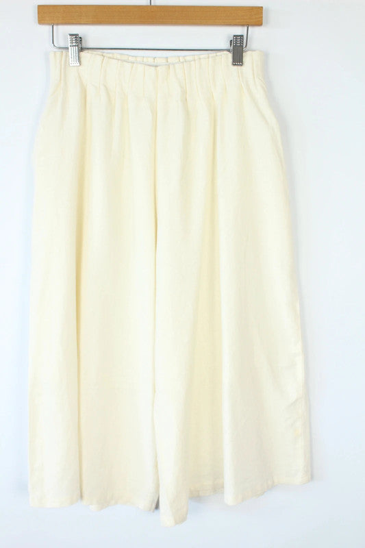 Vintage Dressing cream linen wide-leg culottes high-waisted, lightweight fabric, minimalist design.