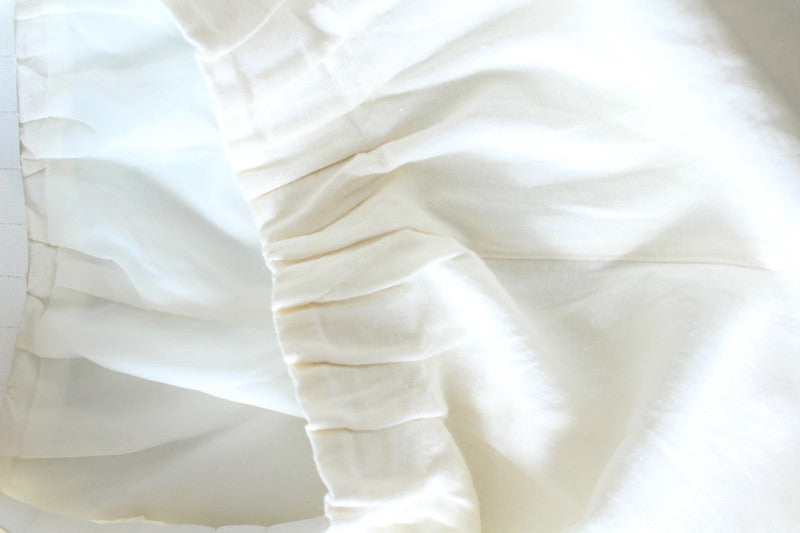 Vintage Dressing cream linen wide-leg culottes high-waisted, lightweight fabric, minimalist design.