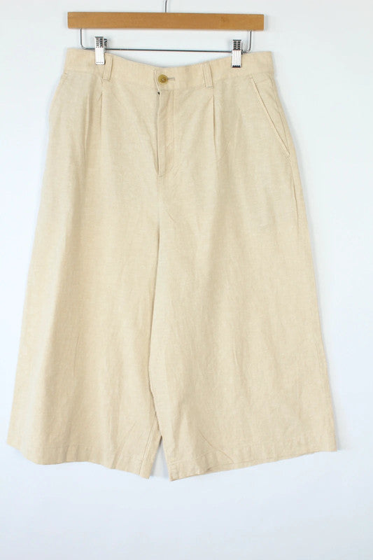 UNIQLO cream linen wide-leg culottes high-waisted with pleated front and tailored fit.