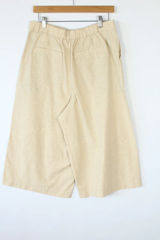 UNIQLO cream linen wide-leg culottes high-waisted with pleated front and tailored fit.
