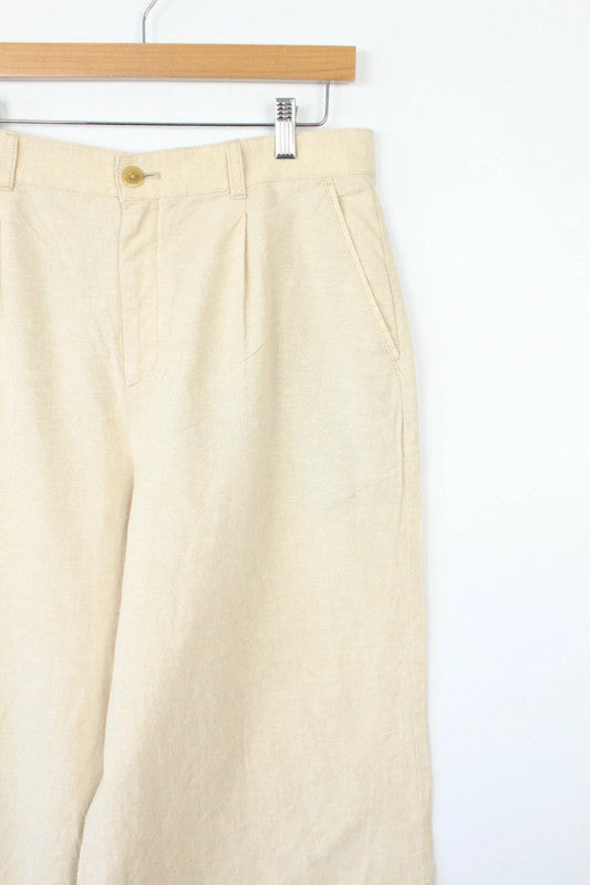 UNIQLO cream linen wide-leg culottes high-waisted with pleated front and tailored fit.
