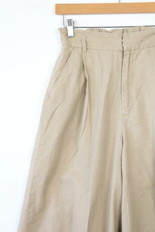 Niko and beige linen wide-leg culottes with high waist and minimalist design.