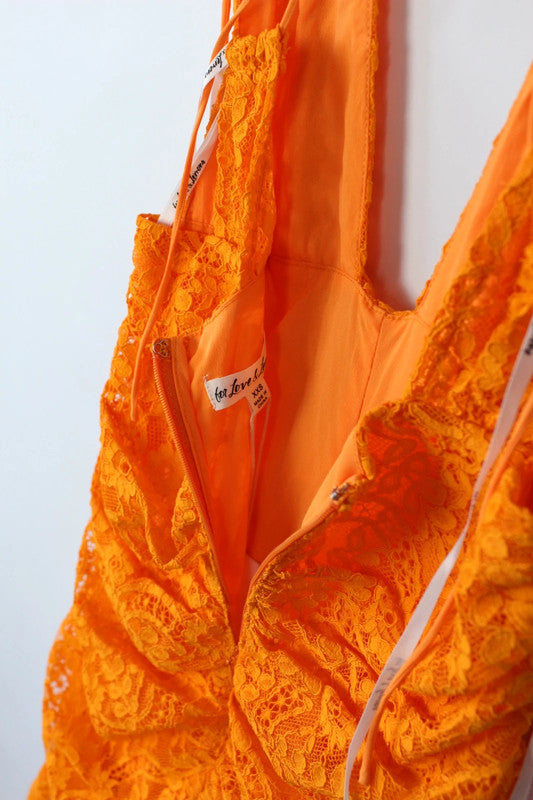 For Love & Lemons orange lace mini dress with floral pattern and plunge V-neckline.