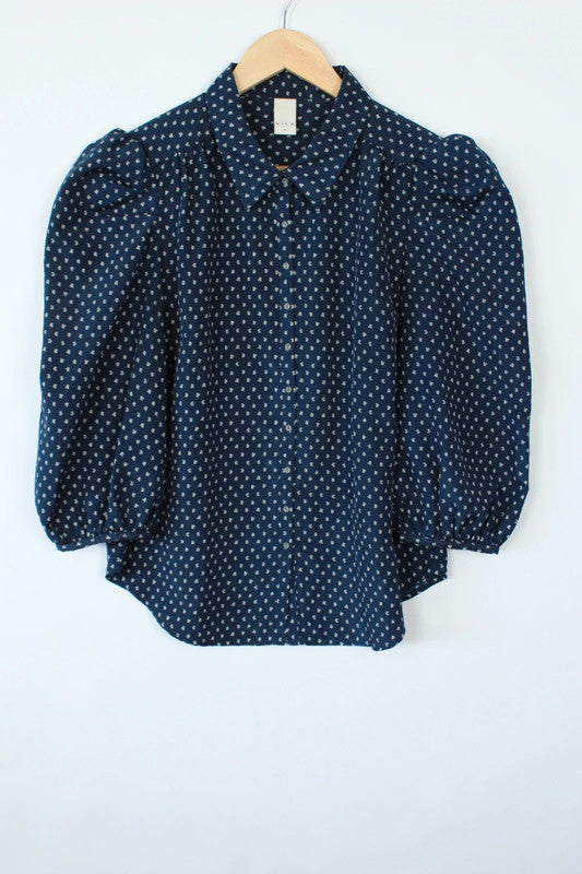 Vila navy blue puff sleeve blouse with white geometric print and button-down front.