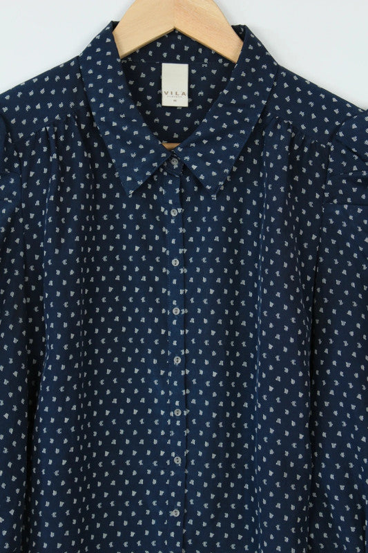 Vila navy blue puff sleeve blouse with white geometric print and button-down front.