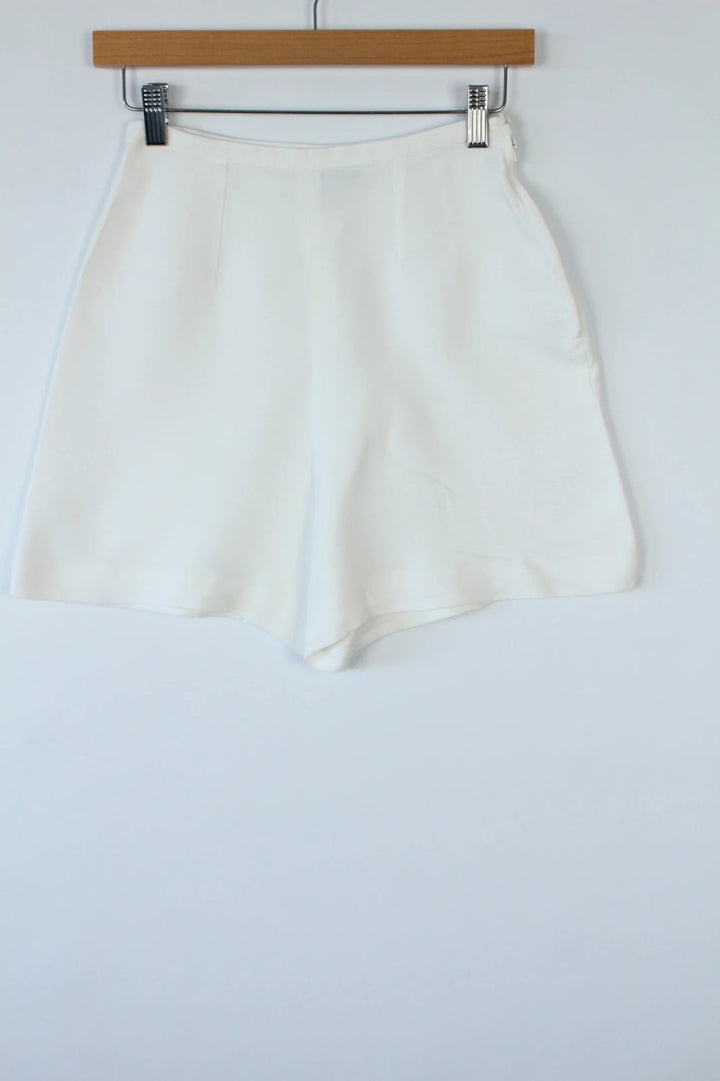 Prisma white tailored shorts, high-waisted A-line fit, clean concealed side zip, cotton blend.