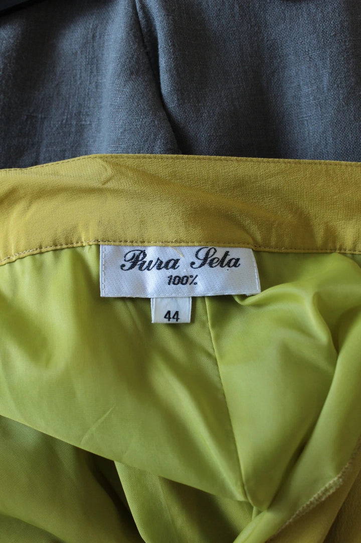Vintage Dressing yellow silk pleated tulip skirt with drape details and side pockets.