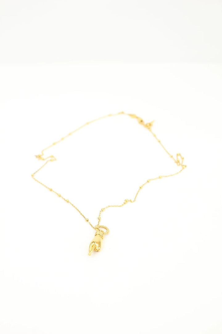 Missoma gold necklace with Good Luck charm pendant and Orb chain design.