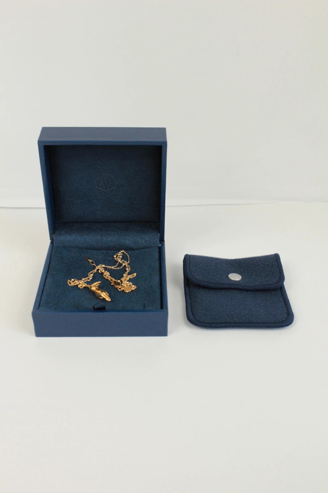 Missoma gold necklace with Good Luck charm pendant and Orb chain design.