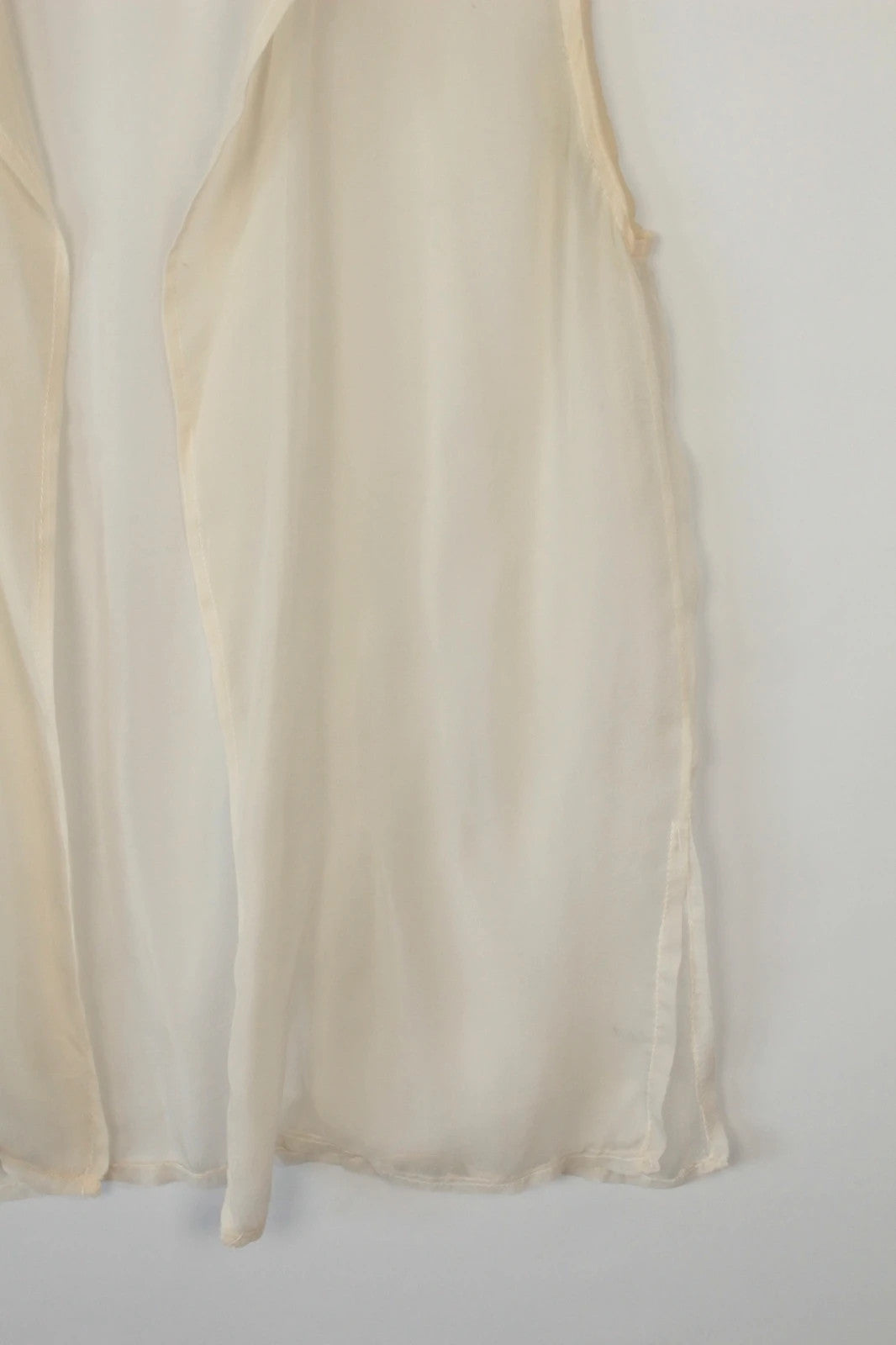 Vintage Dressing cream sleeveless silk tunic blouse with collared neck and sheer fabric.