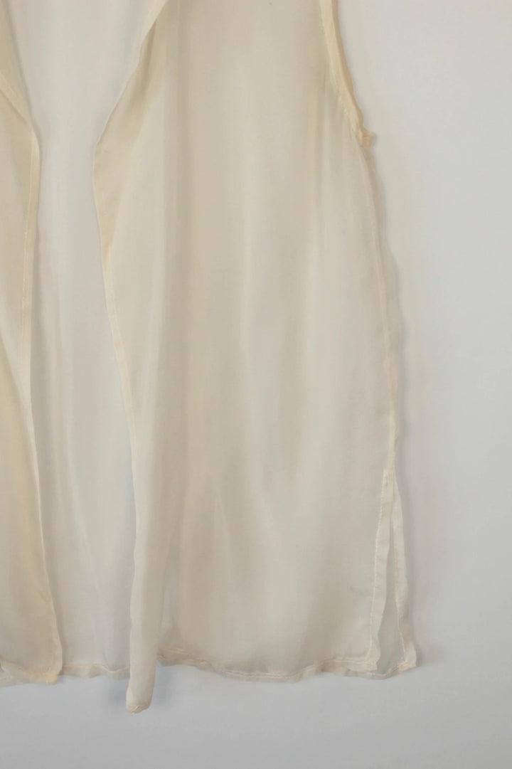 Vintage Dressing cream sleeveless silk tunic blouse with collared neck and sheer fabric.