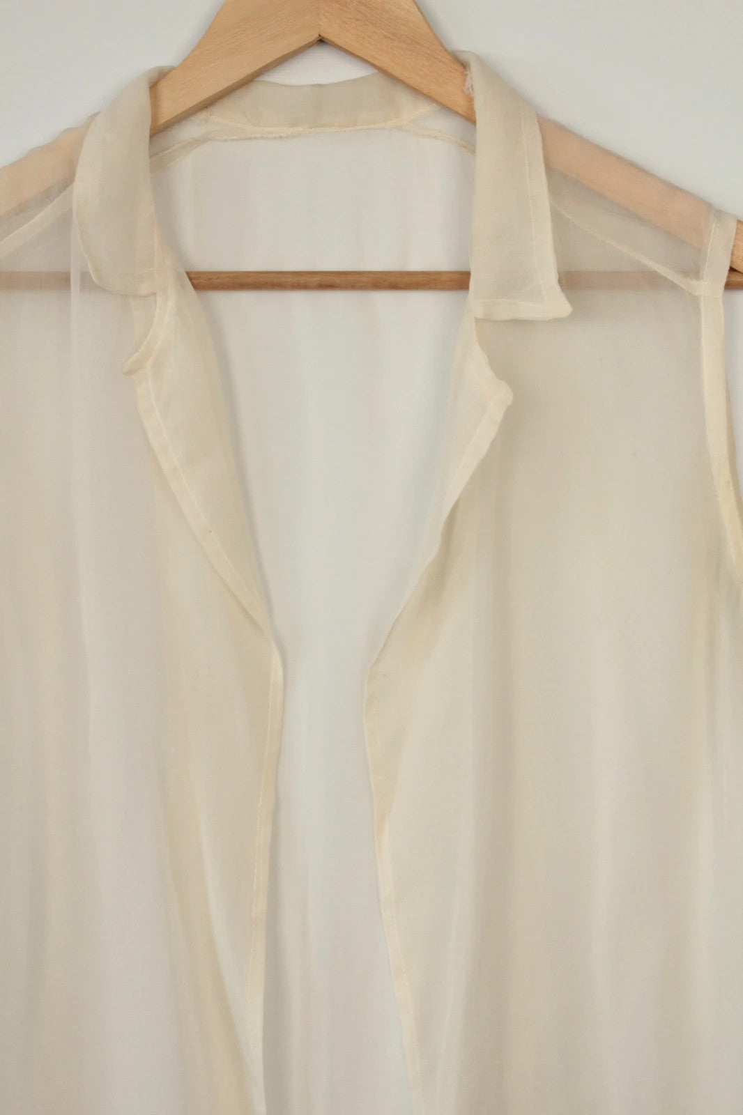 Vintage Dressing cream sleeveless silk tunic blouse with collared neck and sheer fabric.