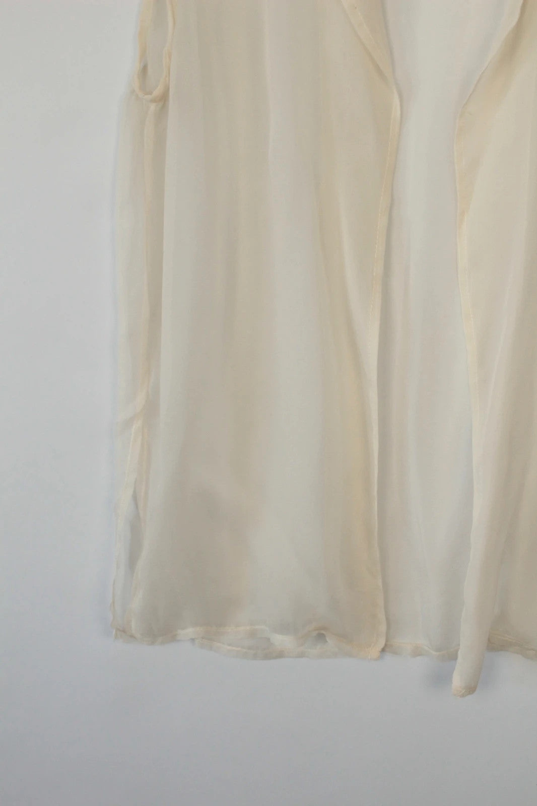 Vintage Dressing cream sleeveless silk tunic blouse with collared neck and sheer fabric.