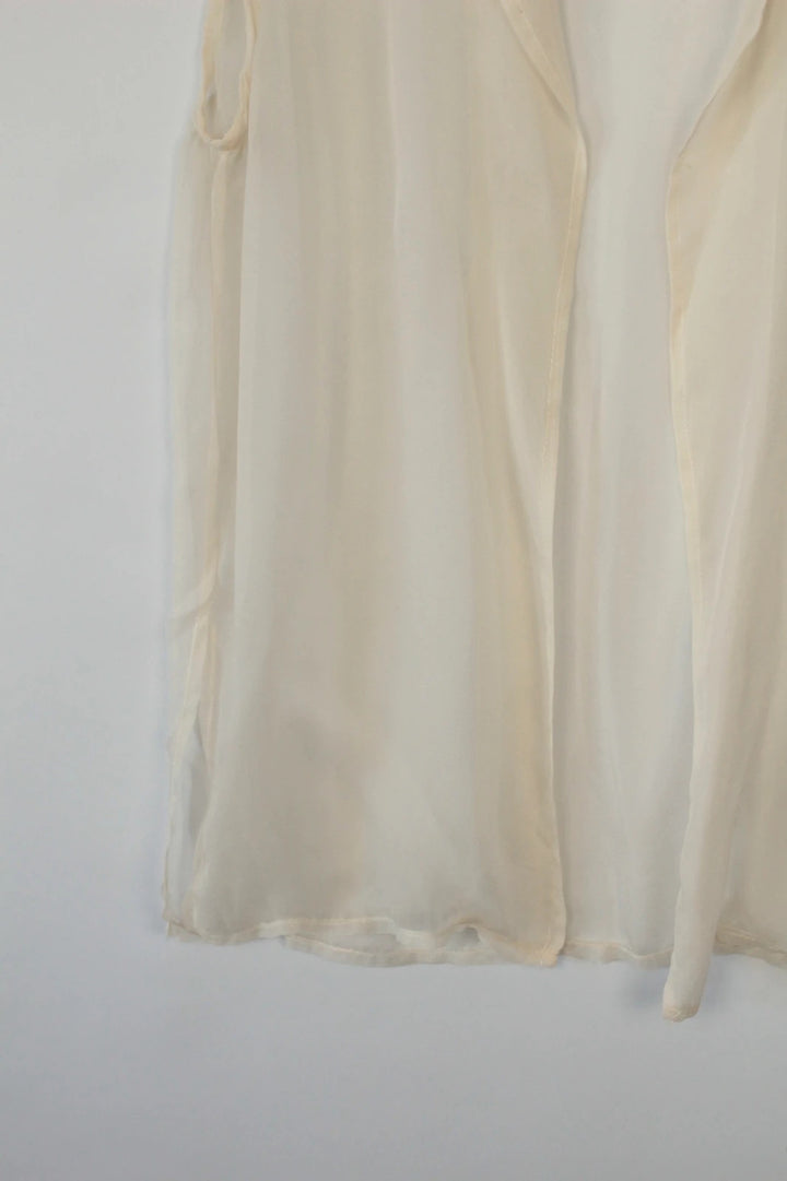 Vintage Dressing cream sleeveless silk tunic blouse with collared neck and sheer fabric.