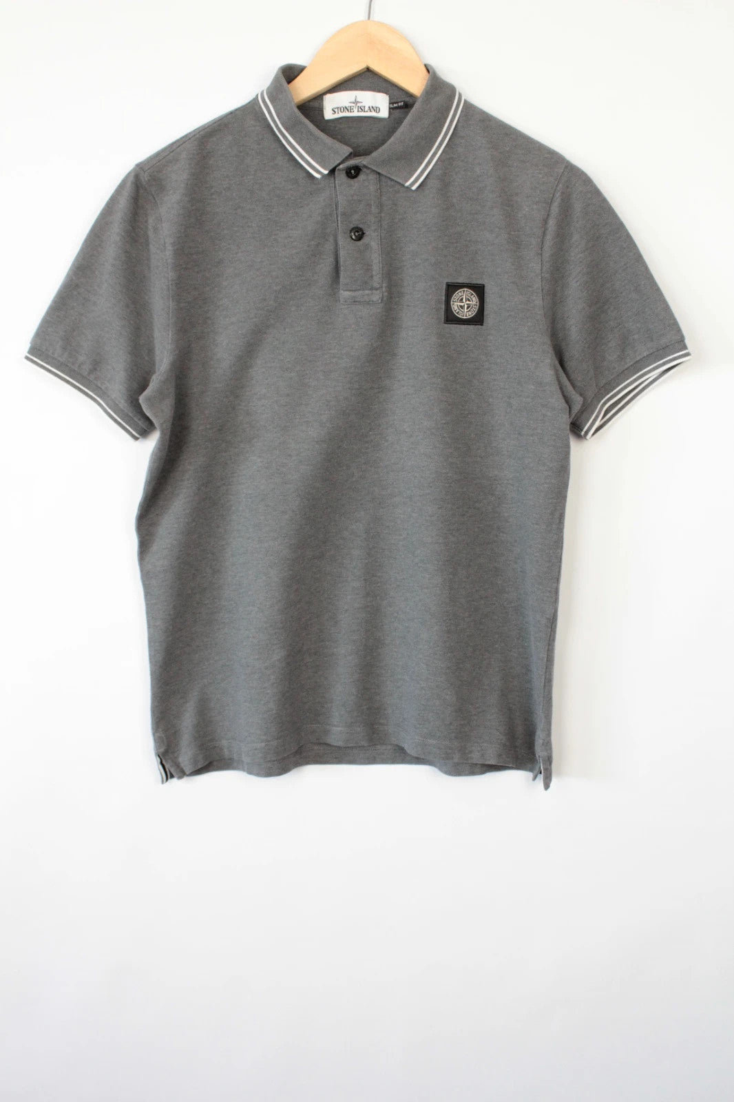 Stone Island grey polo shirt with twin tipped collar and compass badge logo.