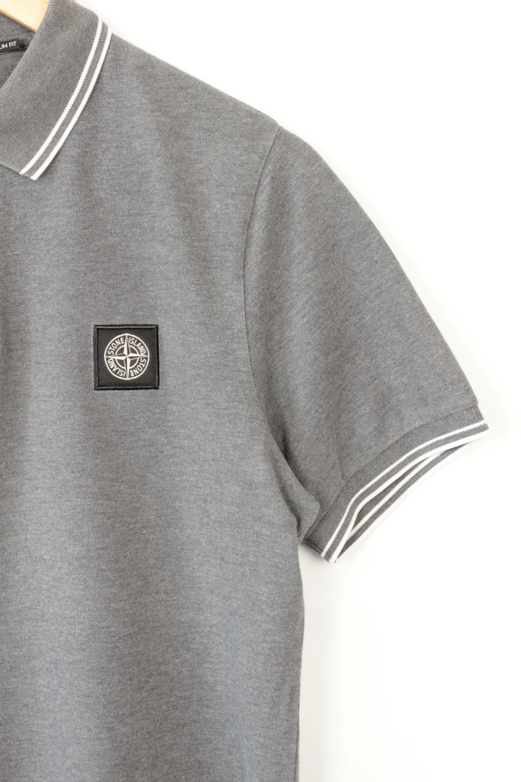 Stone Island grey polo shirt with twin tipped collar and compass badge logo.