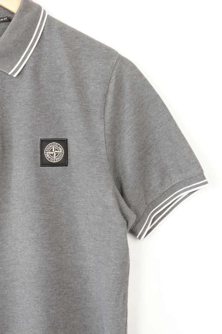 Stone Island grey polo shirt with twin tipped collar and compass badge logo.