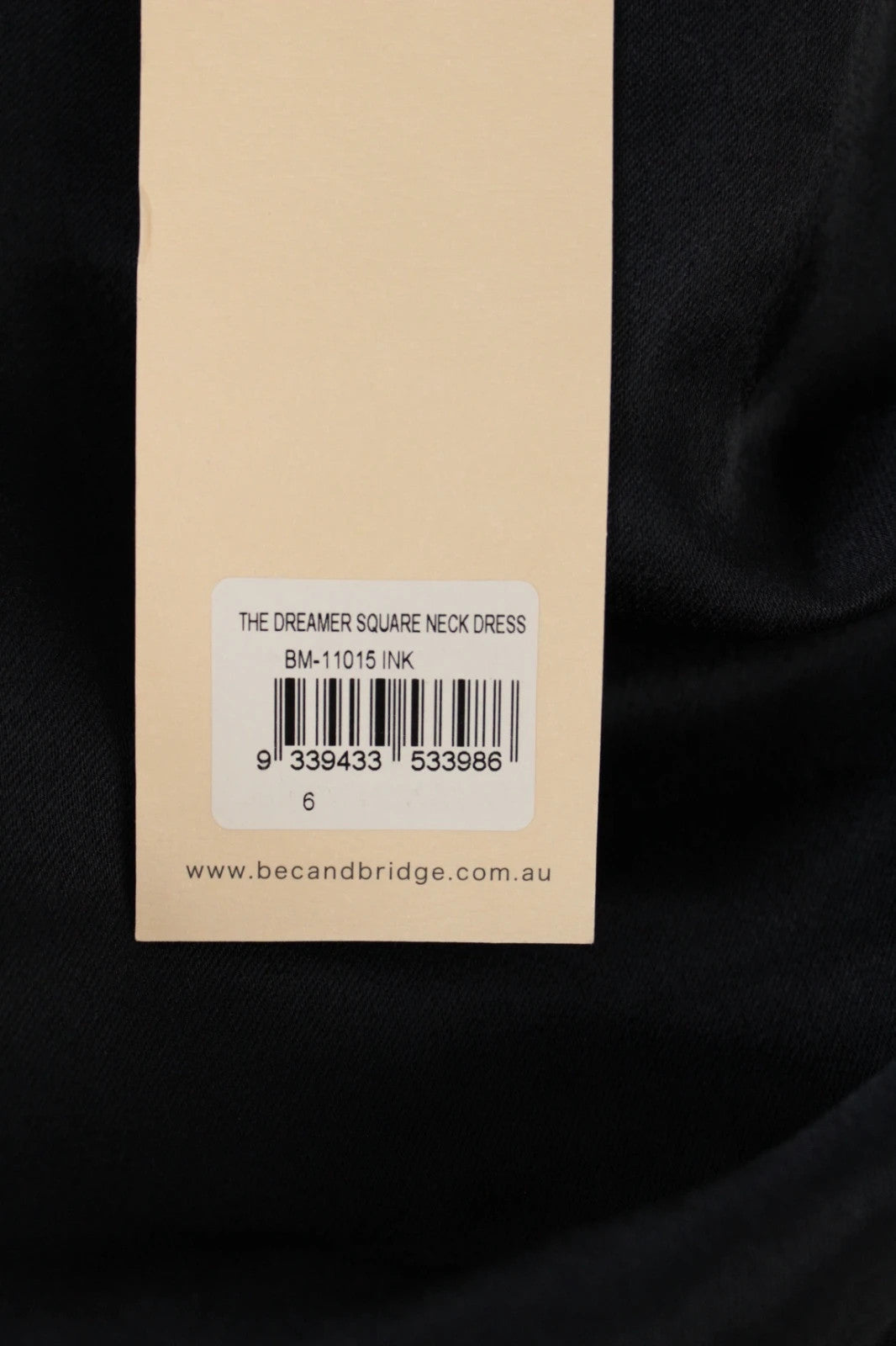 Bec & Bridge deep navy satin maxi dress with square neck and cowl waist detail.