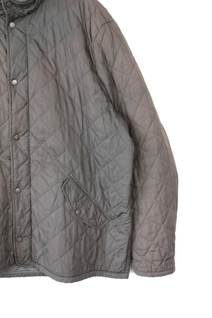 Barbour brown quilted Chelsea jacket with diamond pattern and snap-button storm flap closure.