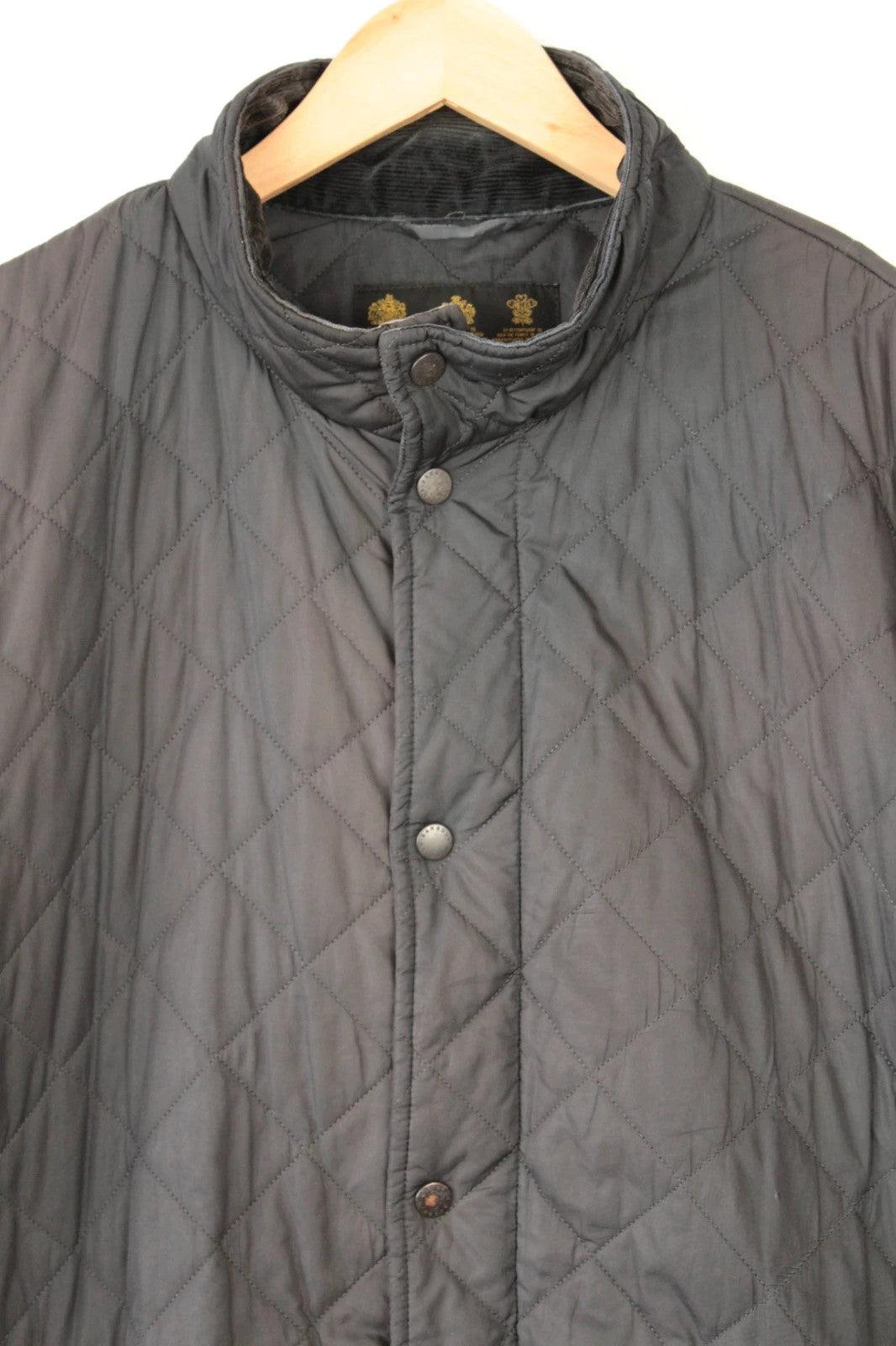 Barbour brown quilted Chelsea jacket with diamond pattern and snap-button storm flap closure.