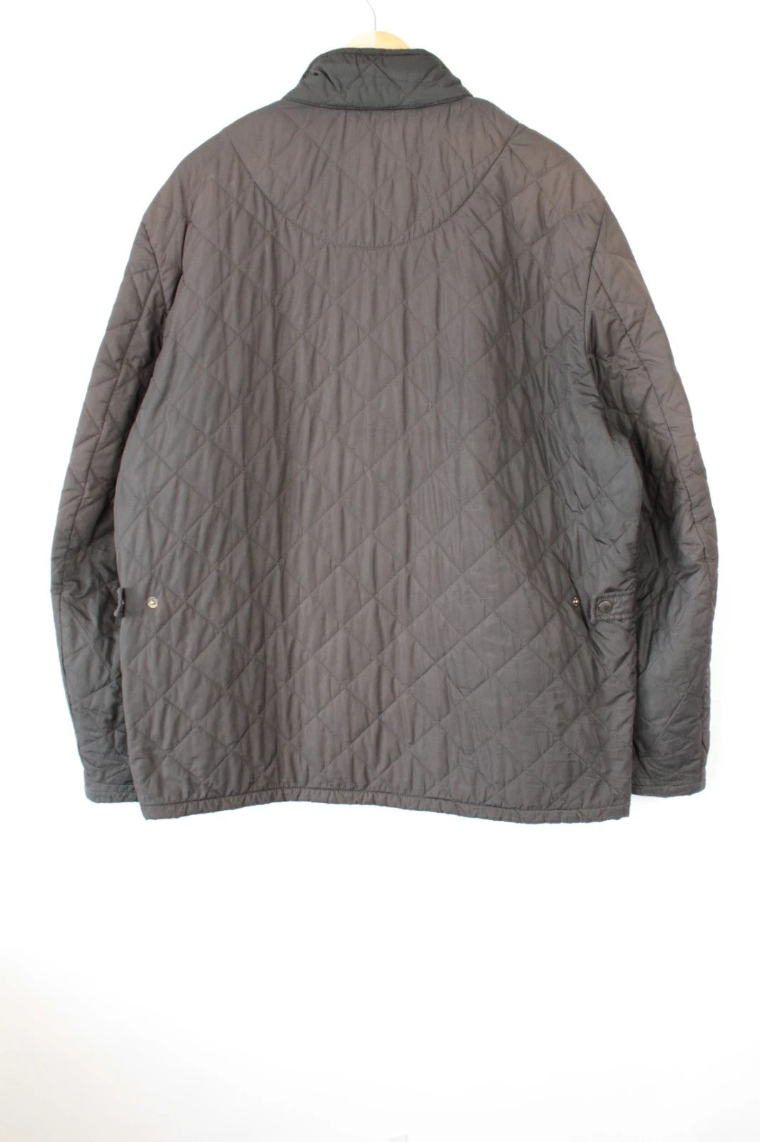 Barbour brown quilted Chelsea jacket with diamond pattern and snap-button storm flap closure.